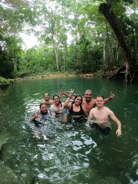 Grupo compartiendo un baño en un pozo natural